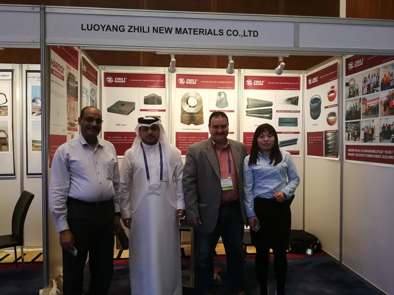 Visitors at the ZL booth in front of mill liner, crusher hammer and blow bar displays