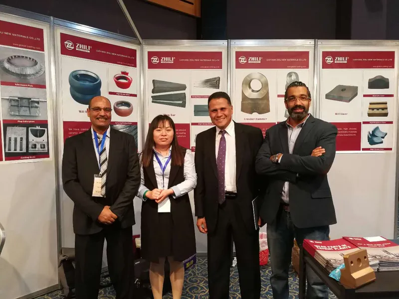 ZL representative and industry visitors beside crusher and mill wear-part displays
