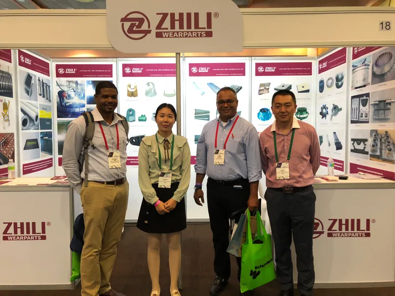 ZL Wearparts team with buyers at a booth displaying crusher and mill component ranges